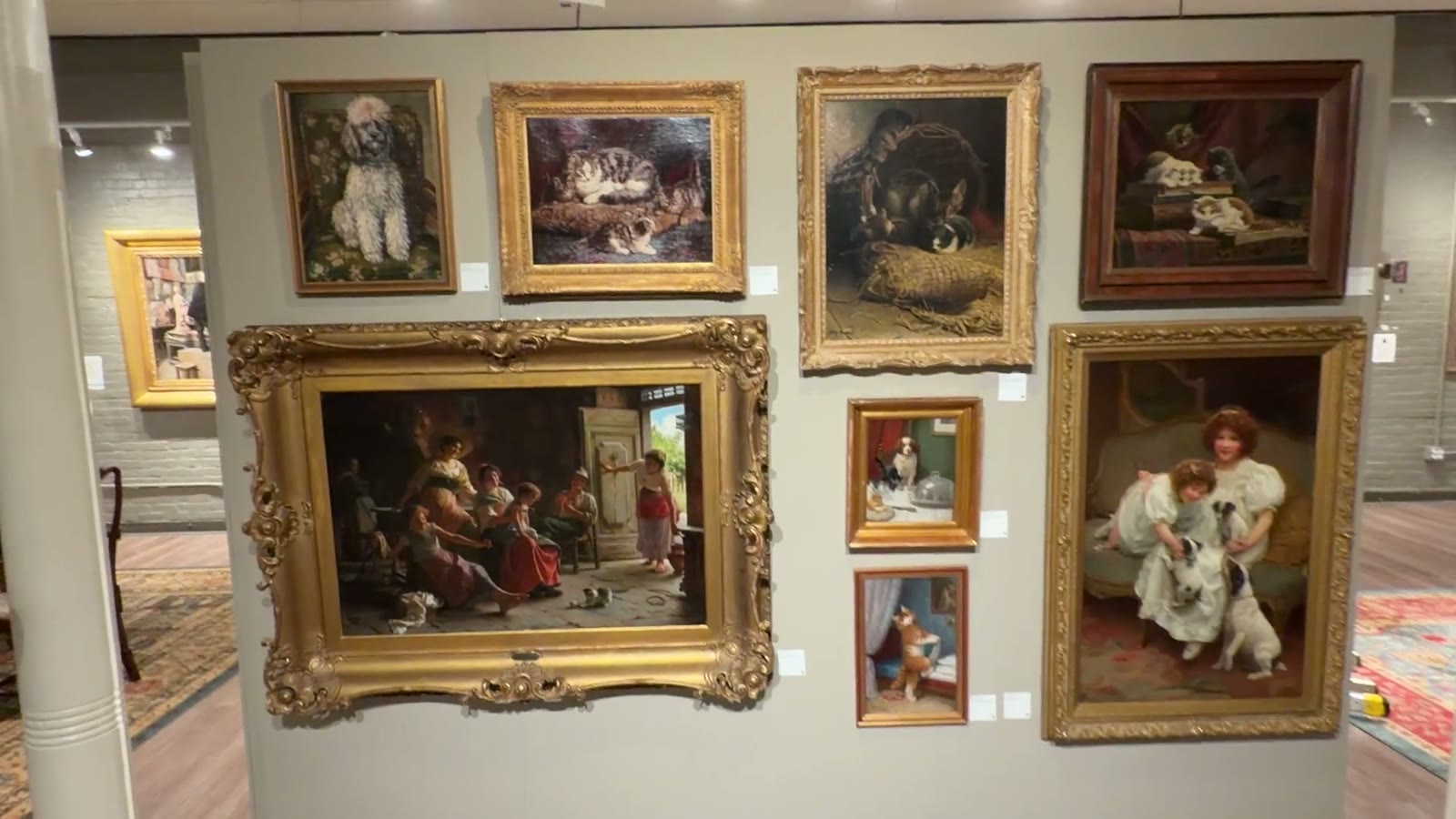 The AWWW Wall of cat and dog paintings in gold frames